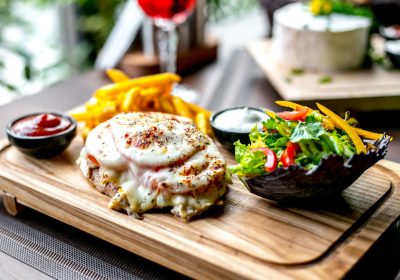 fried-chicken-breast-cheese-tomato-french-fries-ketchup-green-salad-side-view-jpg_141793-1782